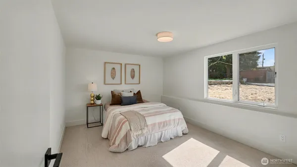 a bedroom with a bed and a large window