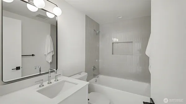 a bathroom with a bathtub a shower a sink and a mirror
