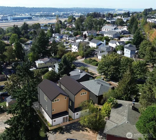 an aerial view of a houses with a city view