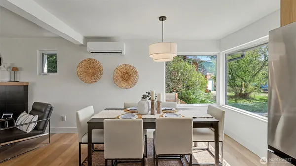 a dining room with furniture a chandelier and wooden floor