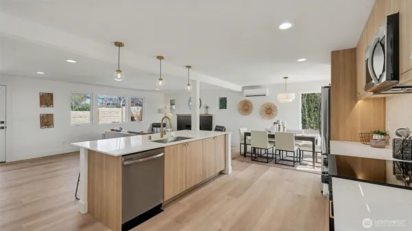 a large kitchen with stainless steel appliances kitchen island granite countertop a large island in the center