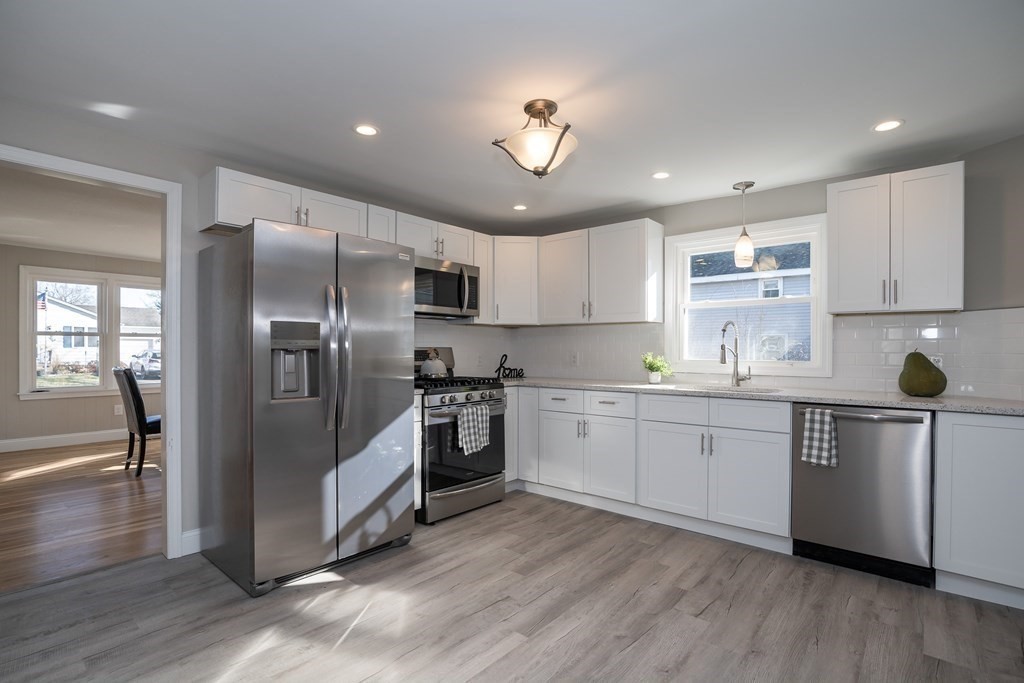 2026 Cross Street Three Rivers, MA 01080 - Photo 1 of 42 a kitchen with granite countertop stainless steel appliances a sink a refrigerator and cabinets