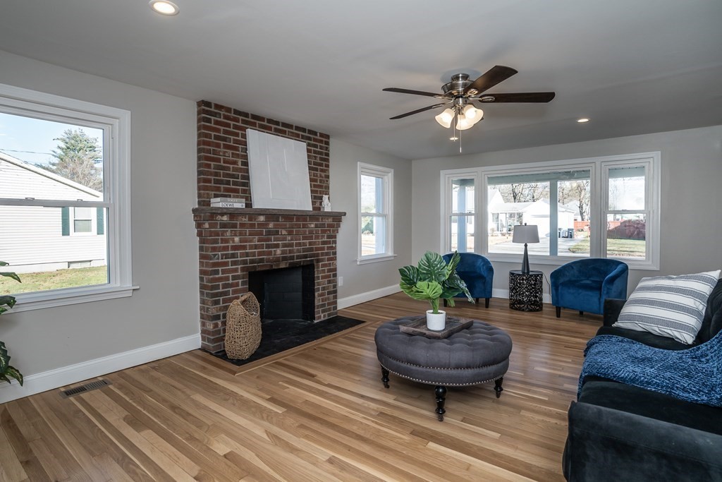 2026 Cross Street Three Rivers, MA 01080 - Photo 11 of 42 a living room with furniture a fireplace and a large window