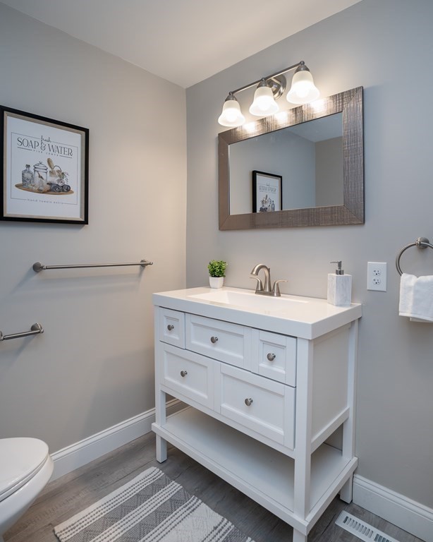 2026 Cross Street Three Rivers, MA 01080 - Photo 16 of 42 a bathroom with a double vanity sink mirror and toilet