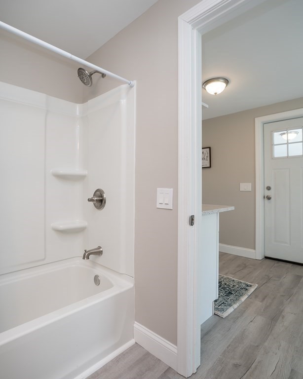 2026 Cross Street Three Rivers, MA 01080 - Photo 17 of 42 a bathroom with a tub shower and a sink