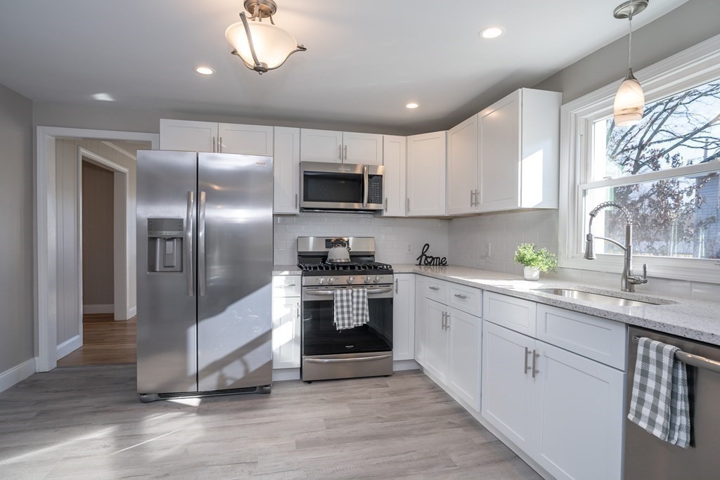 2026 Cross Street Three Rivers, MA 01080 - Photo 3 of 42 a kitchen with cabinets stainless steel appliances a sink and a window
