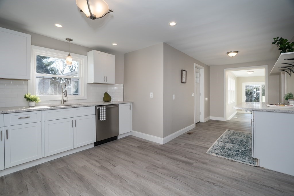 2026 Cross Street Three Rivers, MA 01080 - Photo 4 of 42 a kitchen with a white wooden cabinets and white appliances