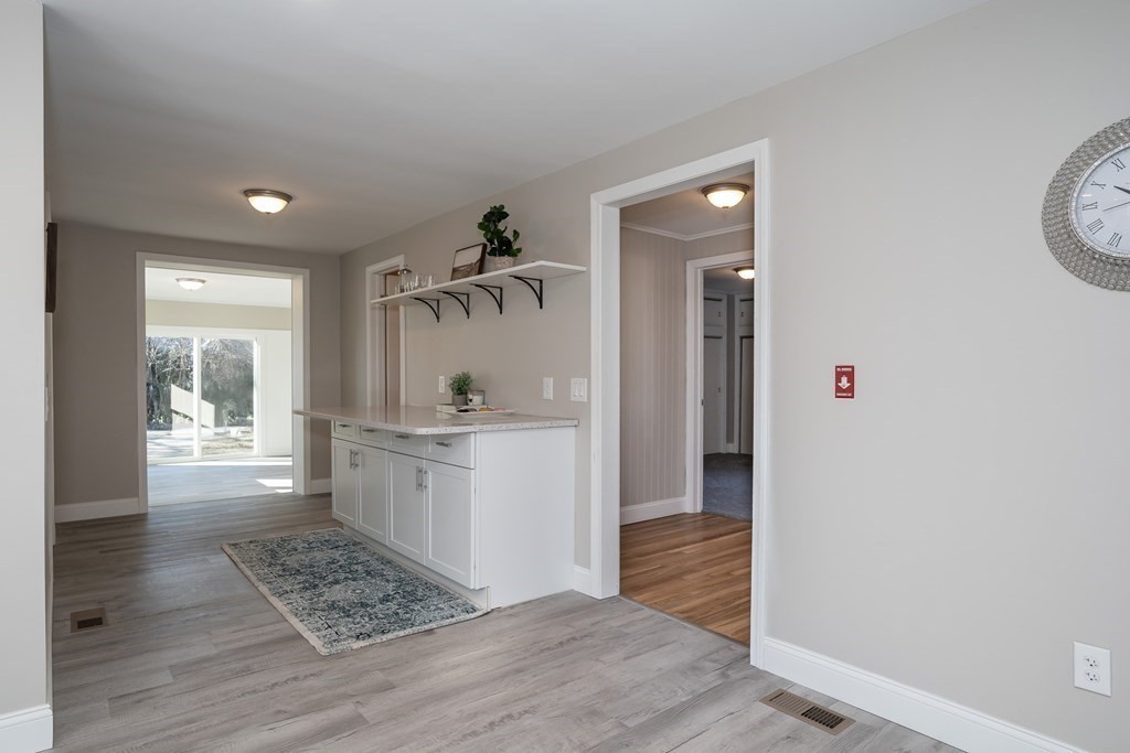 2026 Cross Street Three Rivers, MA 01080 - Photo 7 of 42 a hallway with white cabinets and wooden floor