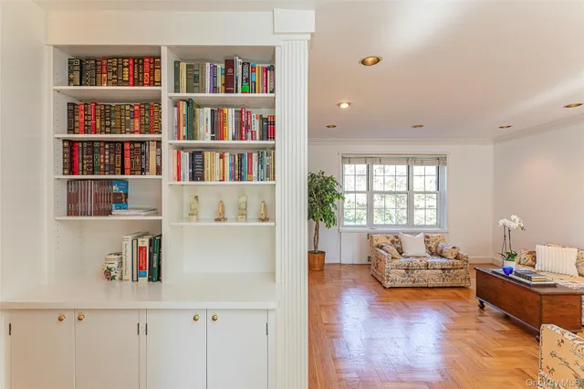 a living room with furniture and a book shelf