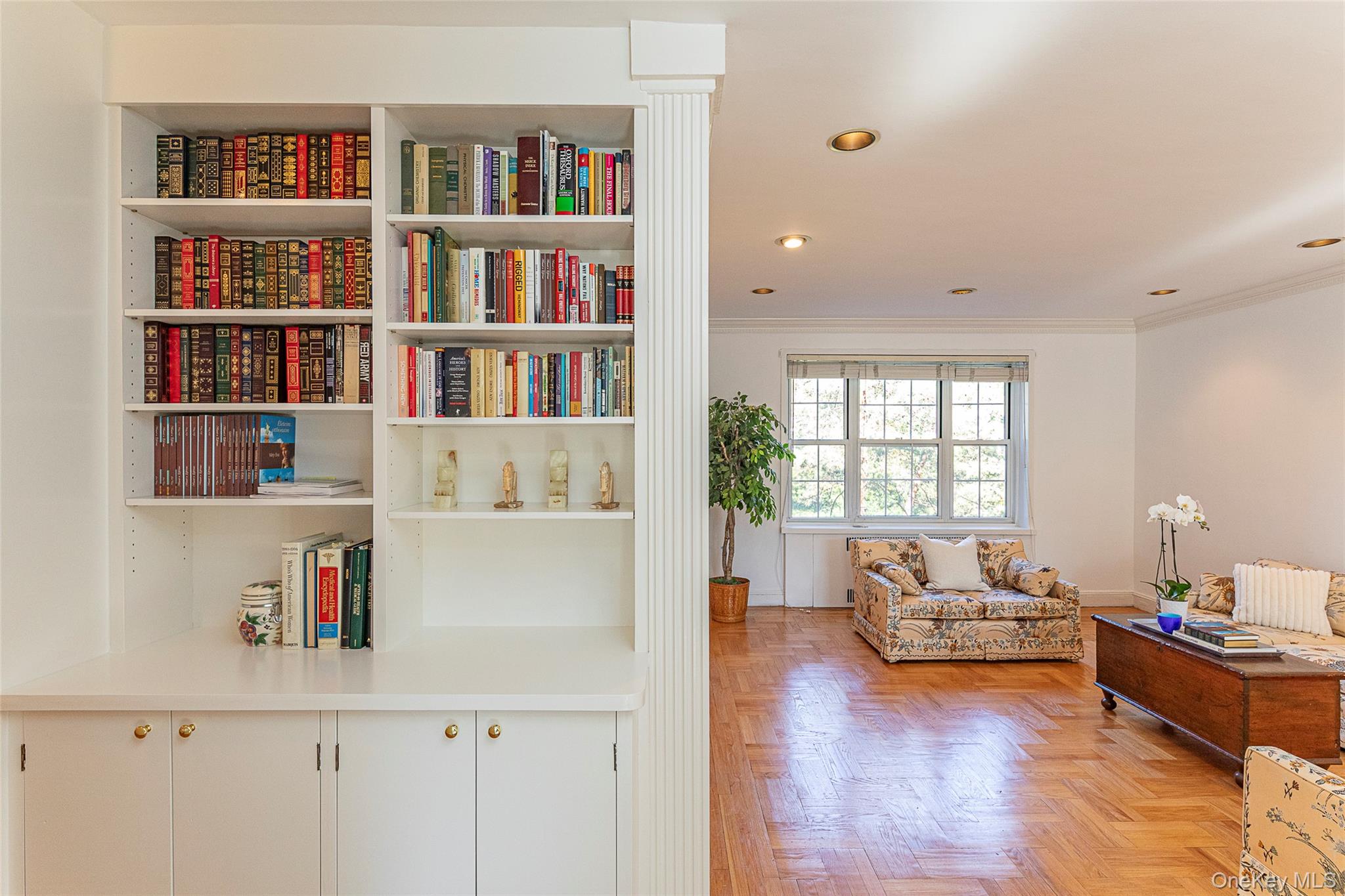 a living room with furniture and a book shelf