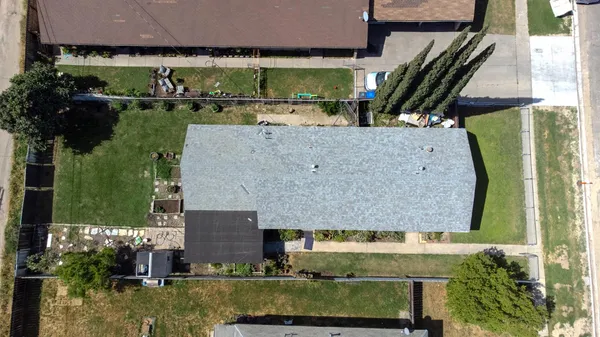 an aerial view of a house with a yard basket ball court and outdoor seating