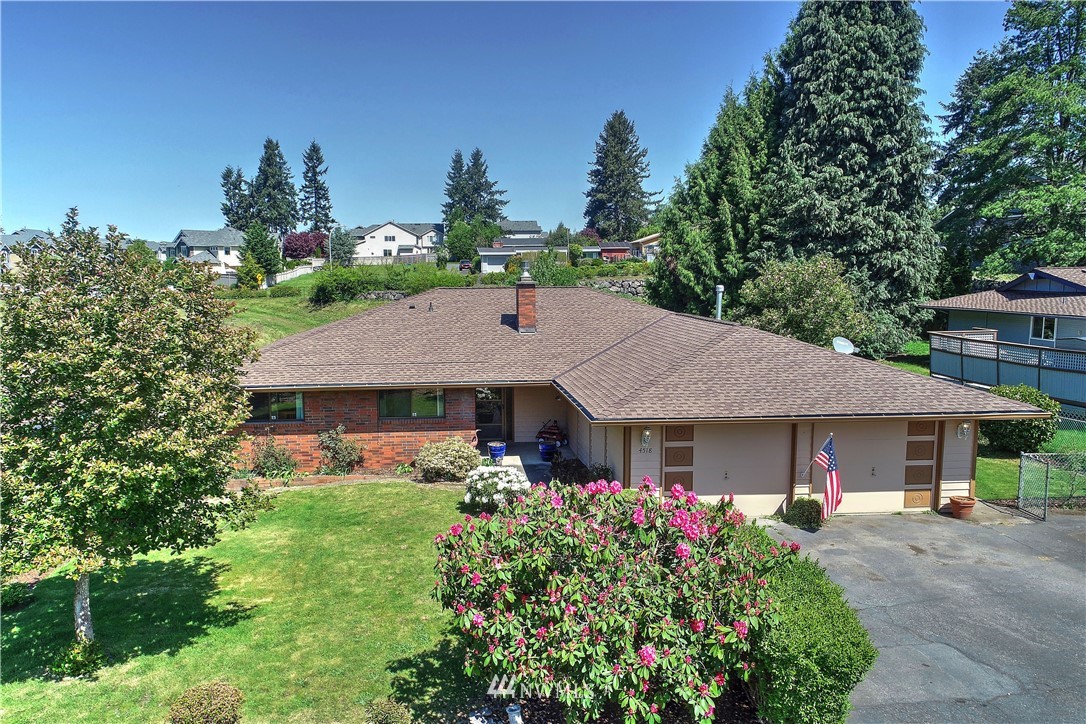 4518 Southeast 2nd Street Renton, WA 98059 - Photo 1 of 29 a front view of a house with garden