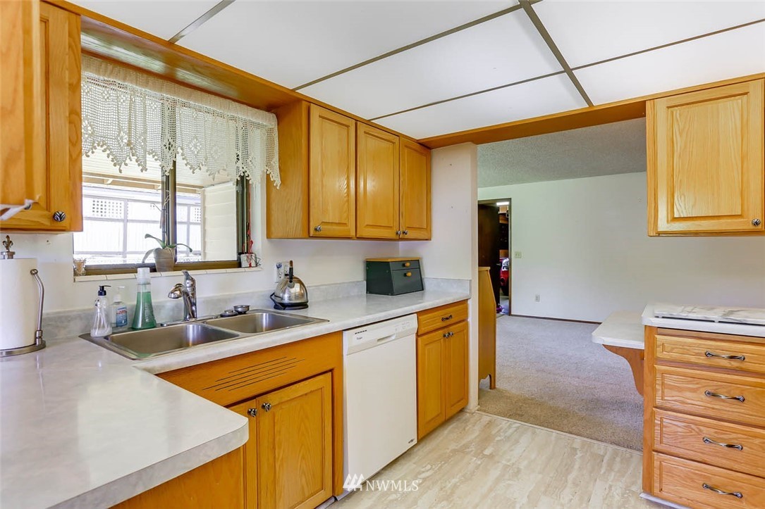4518 Southeast 2nd Street Renton, WA 98059 - Photo 15 of 29 a kitchen with stainless steel appliances granite countertop a sink a stove and a refrigerator