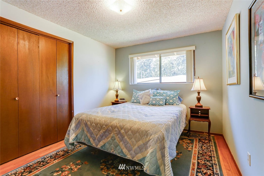4518 Southeast 2nd Street Renton, WA 98059 - Photo 20 of 29 a bedroom with a bed and wooden floor