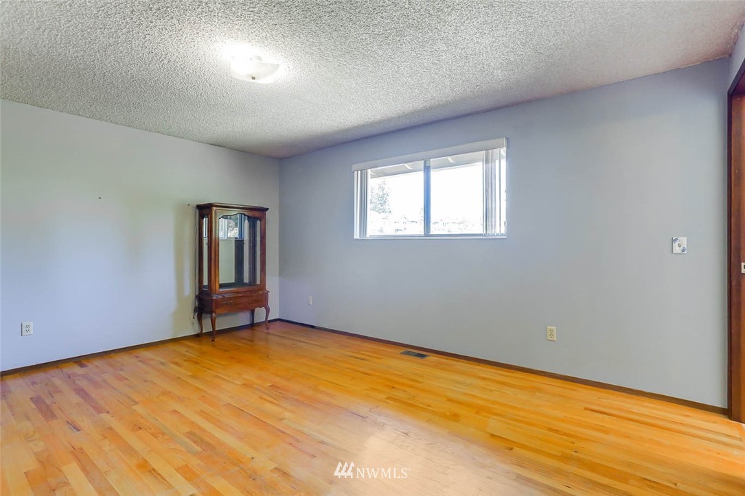 4518 Southeast 2nd Street Renton, WA 98059 - Photo 24 of 29 a view of an empty room with wooden floor and a window