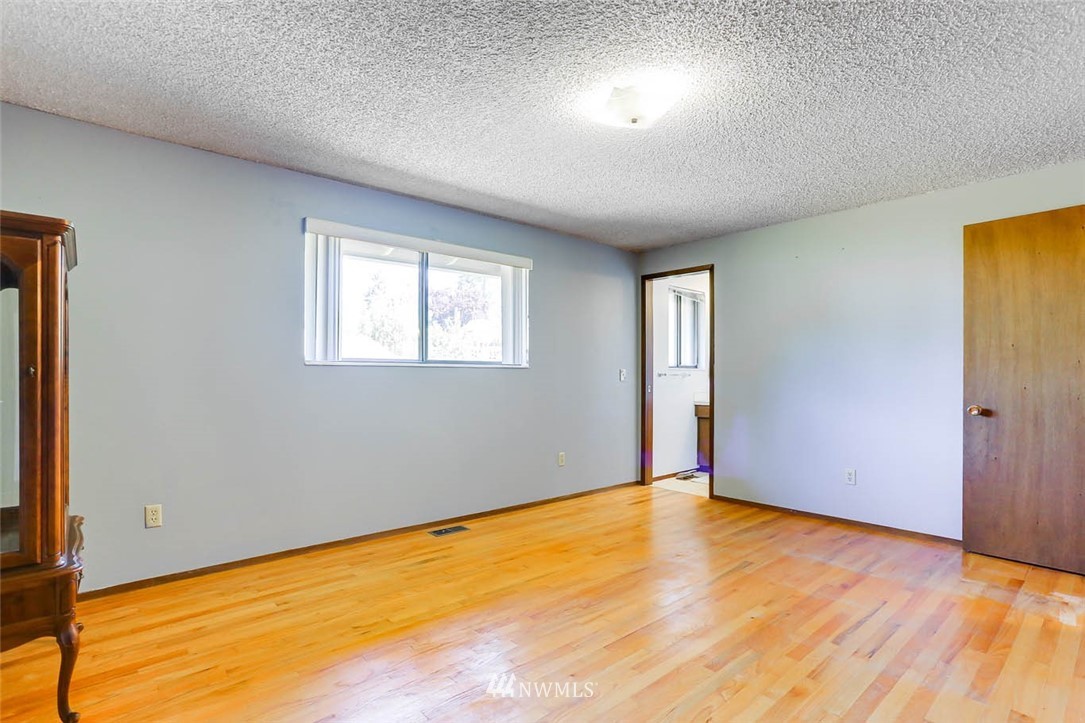 4518 Southeast 2nd Street Renton, WA 98059 - Photo 25 of 29 a view of an empty room with wooden floor and a window