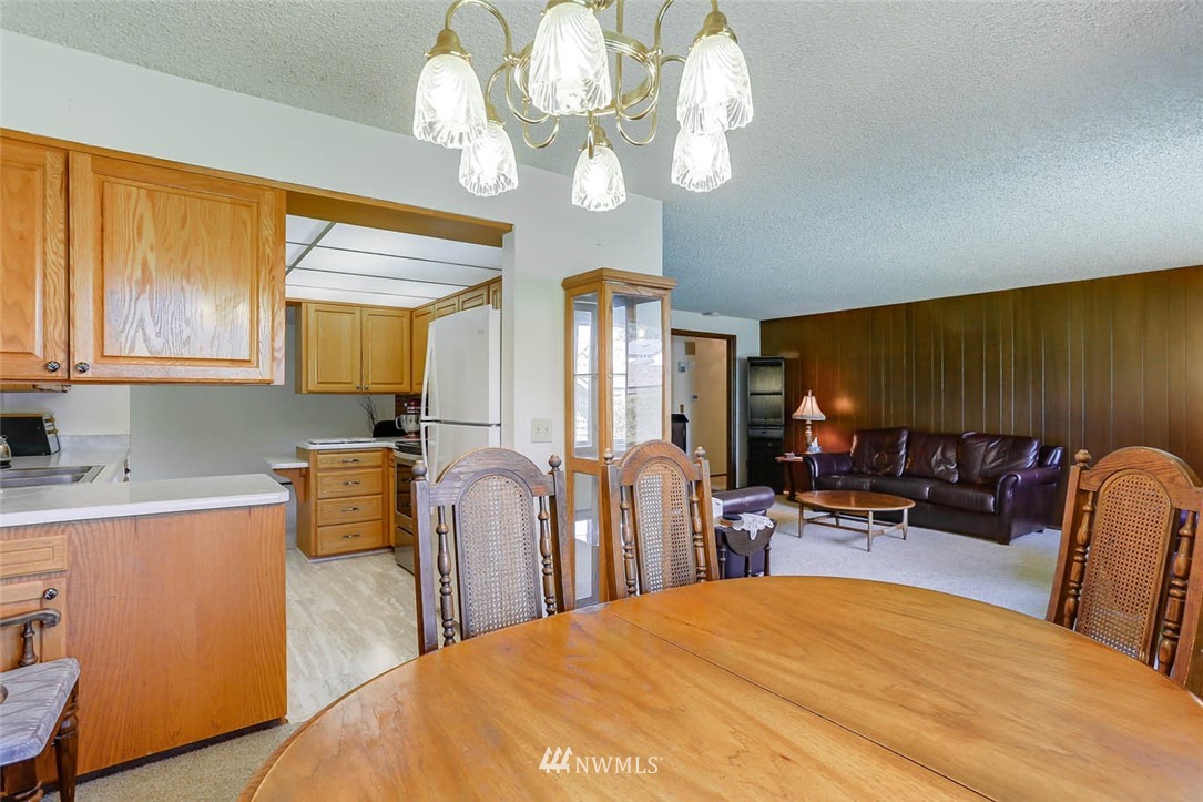 4518 Southeast 2nd Street Renton, WA 98059 - Photo 10 of 29 a bed room with a bed mirror and a chandelier