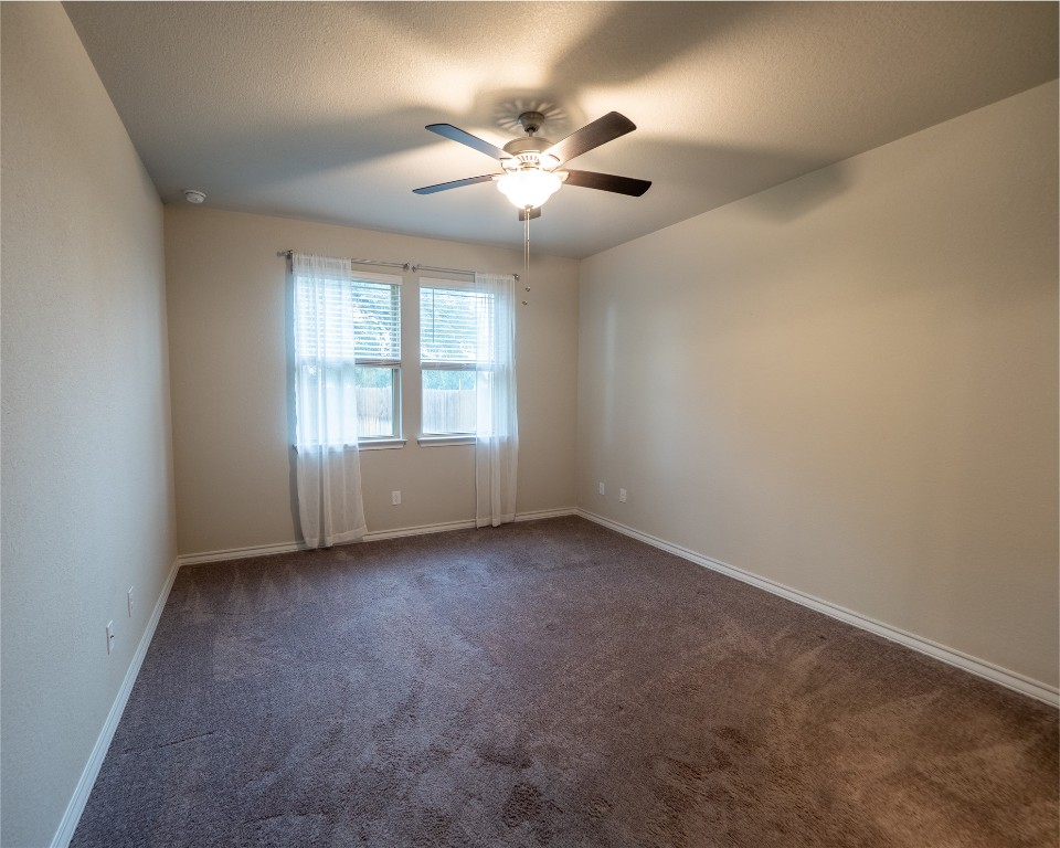 1320 Eagle Ray Street Leander, TX 78641 - Photo 22 of 30 an empty room with a window and a ceiling fan