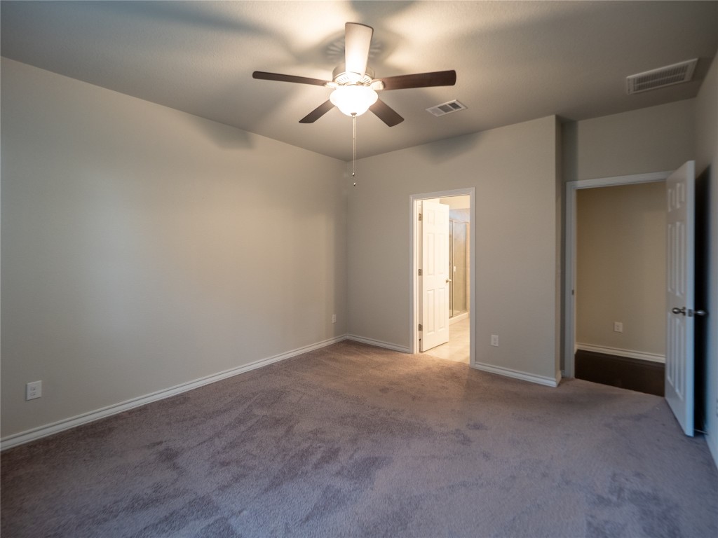 1320 Eagle Ray Street Leander, TX 78641 - Photo 23 of 30 an empty room with chandelier fan and windows