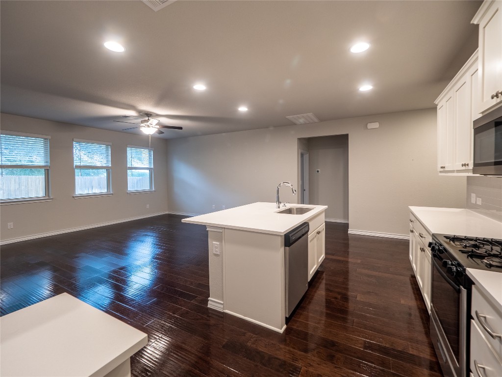1320 Eagle Ray Street Leander, TX 78641 - Photo 6 of 30 a kitchen with sink stove and wooden floor