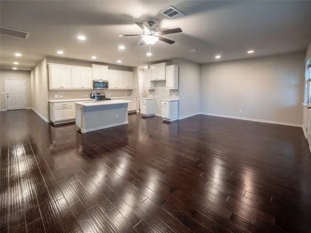 a view of kitchen with cabinets and wooden floor