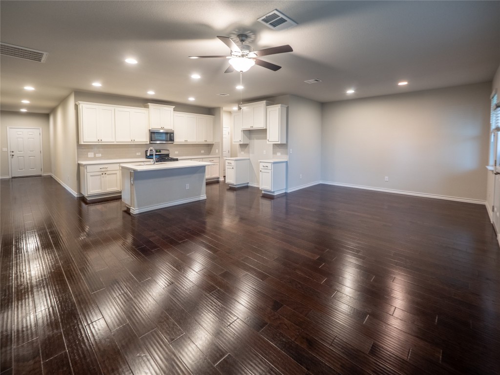 1320 Eagle Ray Street Leander, TX 78641 - Photo 7 of 30 a view of kitchen with cabinets and wooden floor