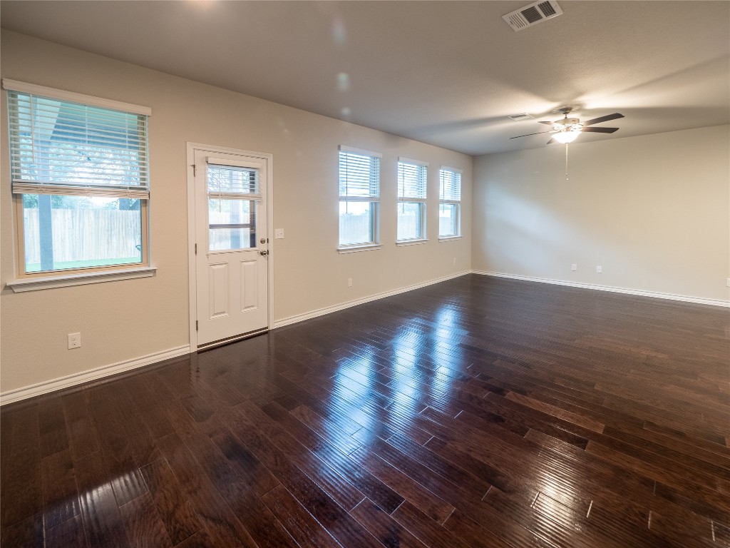 1320 Eagle Ray Street Leander, TX 78641 - Photo 10 of 30 a view of an empty room with wooden floor and a window