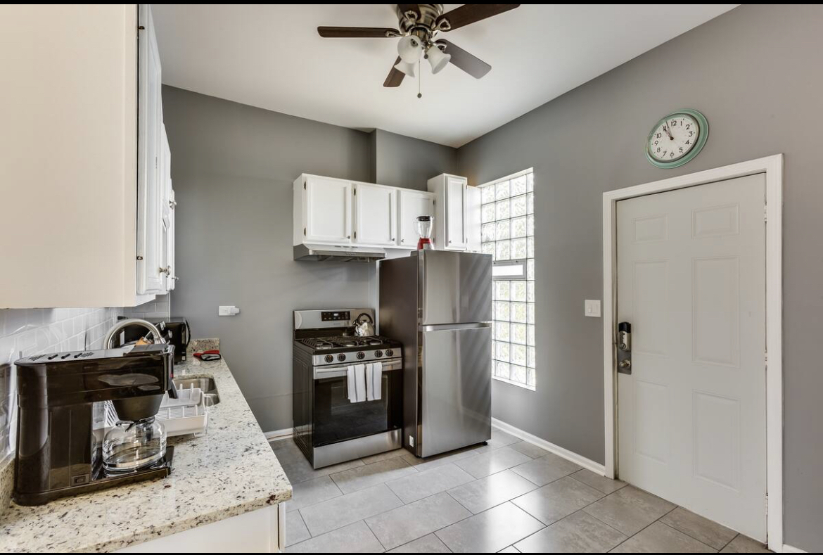 3140 West Fulton Street Chicago, IL 60612 - Photo 11 of 23 a kitchen with stainless steel appliances granite countertop a refrigerator and a stove