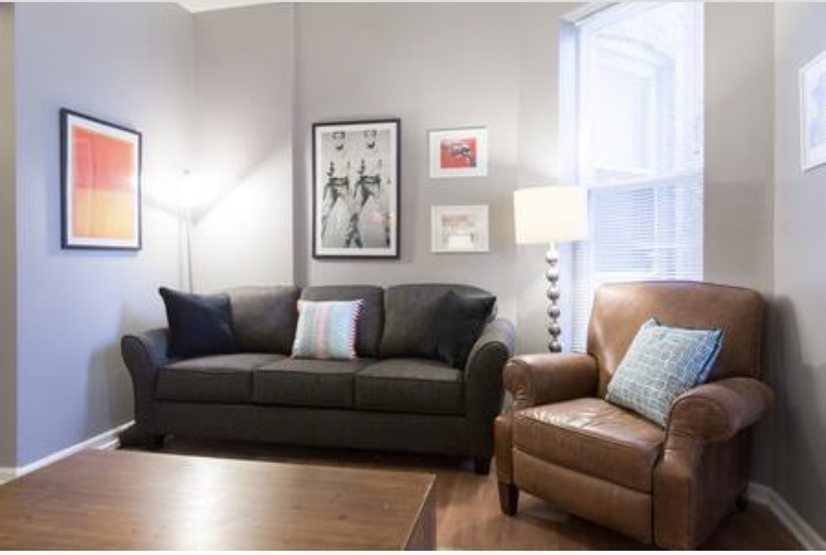 3140 West Fulton Street Chicago, IL 60612 - Photo 20 of 23 a living room with furniture a couch and paintings on the wall