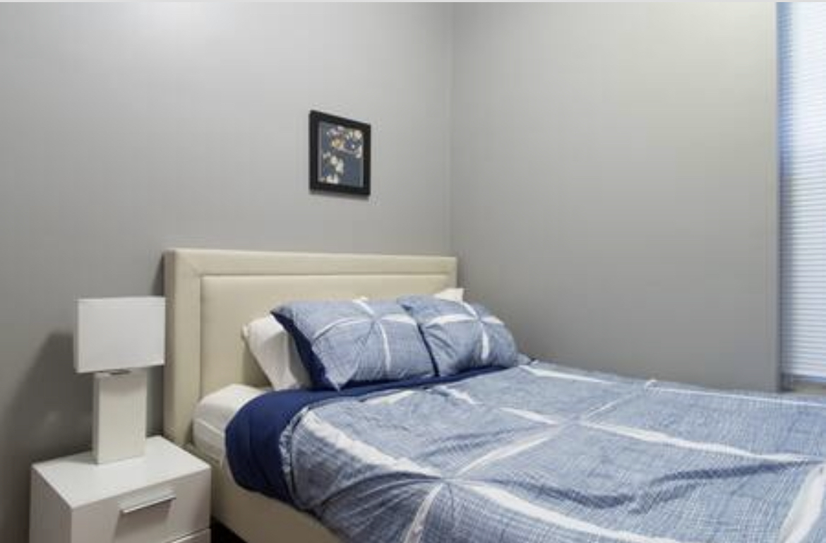 3140 West Fulton Street Chicago, IL 60612 - Photo 21 of 23 a bedroom with a bed and a lamp on the dresser