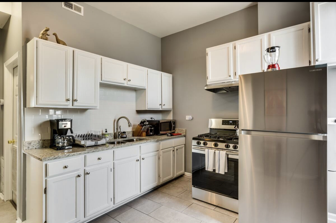 3140 West Fulton Street Chicago, IL 60612 - Photo 10 of 23 a kitchen with stainless steel appliances a refrigerator sink and cabinets