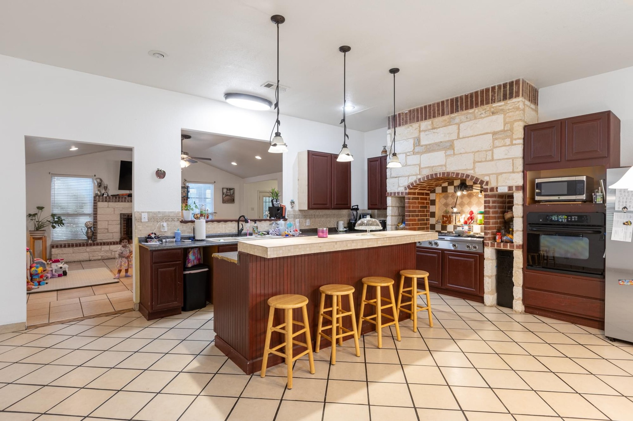 176 Old Lexington Road, Unit C Elgin, TX 78621 - Photo 11 of 31 a kitchen with stainless steel appliances kitchen island granite countertop a sink and cabinets