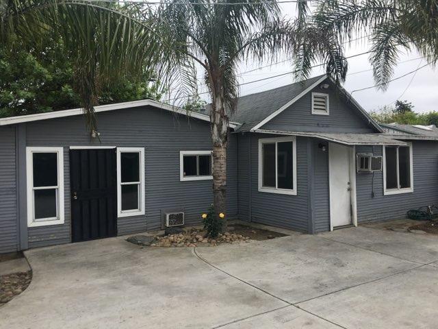 1315 D Street, Unit 2 Reedley, CA 93654 - Photo 3 of 4 a house that has a tree in front of it
