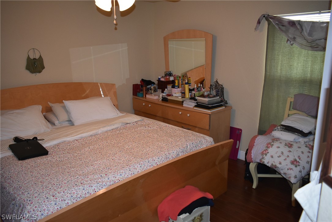 5264 Glenlivet Road Fort Myers, FL 33907 - Photo 11 of 15 a bedroom with a bed and a mirror