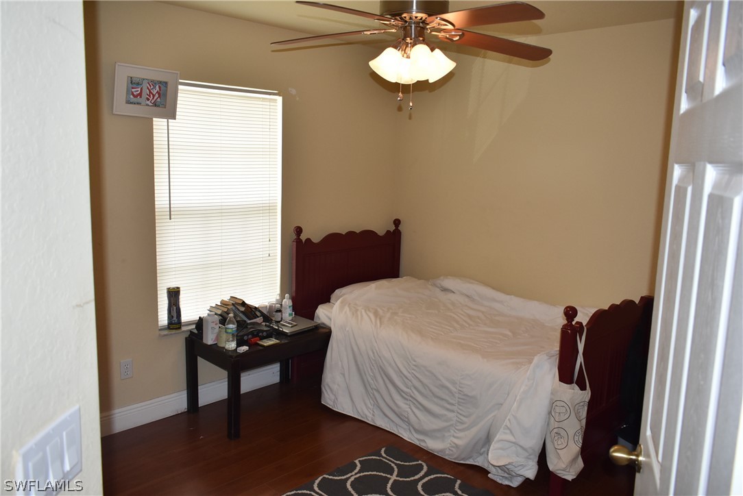 5264 Glenlivet Road Fort Myers, FL 33907 - Photo 14 of 15 a bedroom with a bed and a chandelier