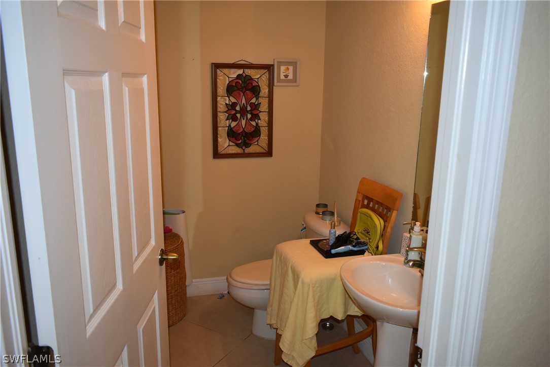 5264 Glenlivet Road Fort Myers, FL 33907 - Photo 3 of 15 a bathroom with a toilet a sink and a mirror