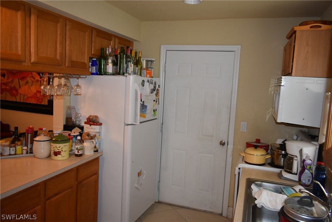 5264 Glenlivet Road Fort Myers, FL 33907 - Photo 5 of 15 a kitchen with refrigerator and sink