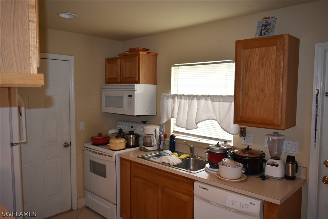 5264 Glenlivet Road Fort Myers, FL 33907 - Photo 6 of 15 a kitchen with a sink cabinets and a window