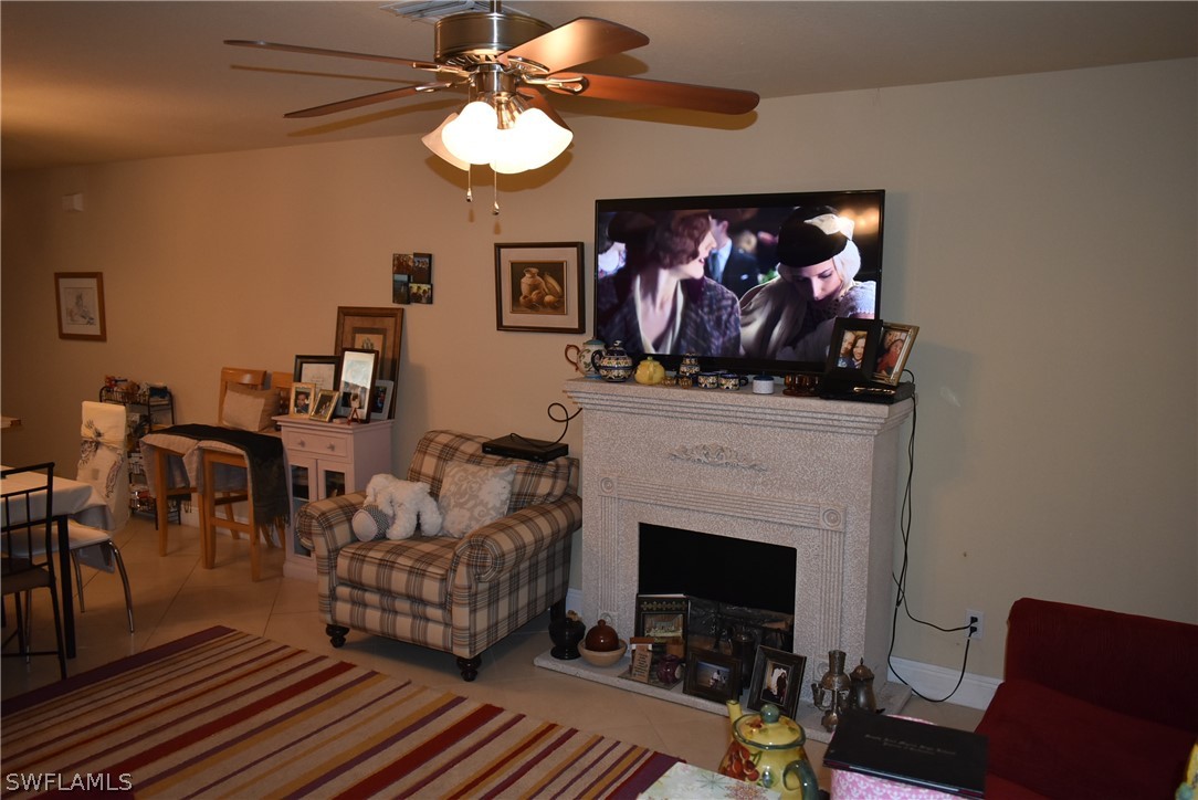 5264 Glenlivet Road Fort Myers, FL 33907 - Photo 8 of 15 a living room with furniture a fireplace and a flat screen tv