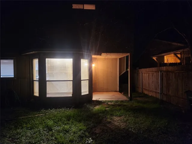 a view of backyard with potted plants and wooden floor