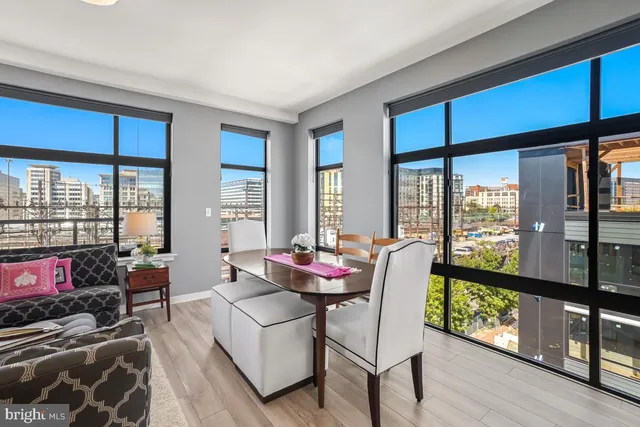 a living room with furniture and a floor to ceiling window