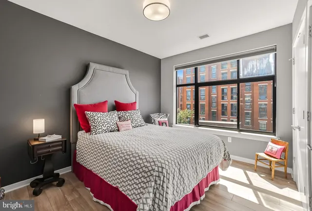 a bedroom with a bed and wooden floor