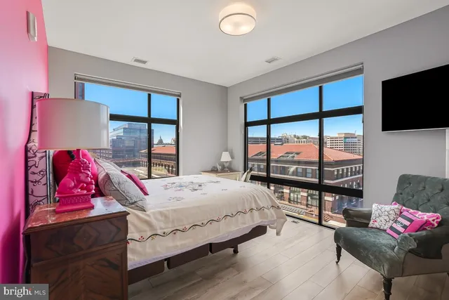 a bedroom with a bed and large window