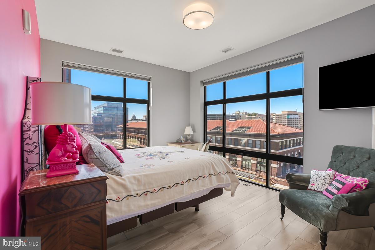 911 2nd Street Northeast, Unit 501 Washington, DC 20002 - Photo 17 of 30 a bedroom with a bed and large window