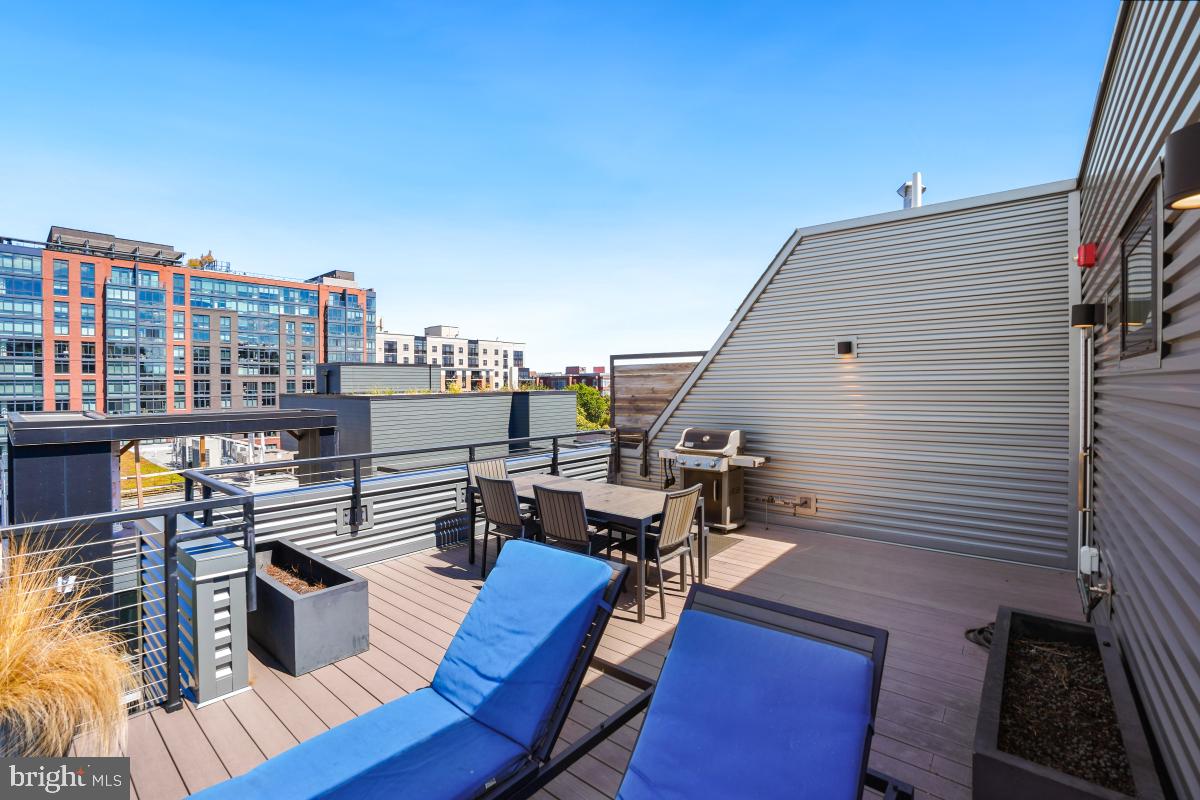 911 2nd Street Northeast, Unit 501 Washington, DC 20002 - Photo 26 of 30 a view of a roof deck with dining table and chairs with wooden floor