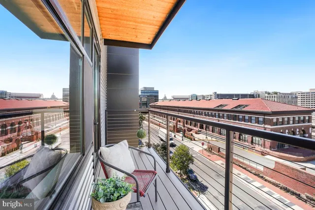 a balcony with an outdoor seating