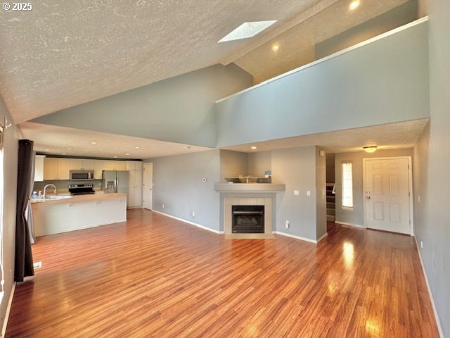 37355 Coralburst Street Sandy, OR 97055 - Photo 12 of 30 a view of empty room with wooden floor and kitchen view