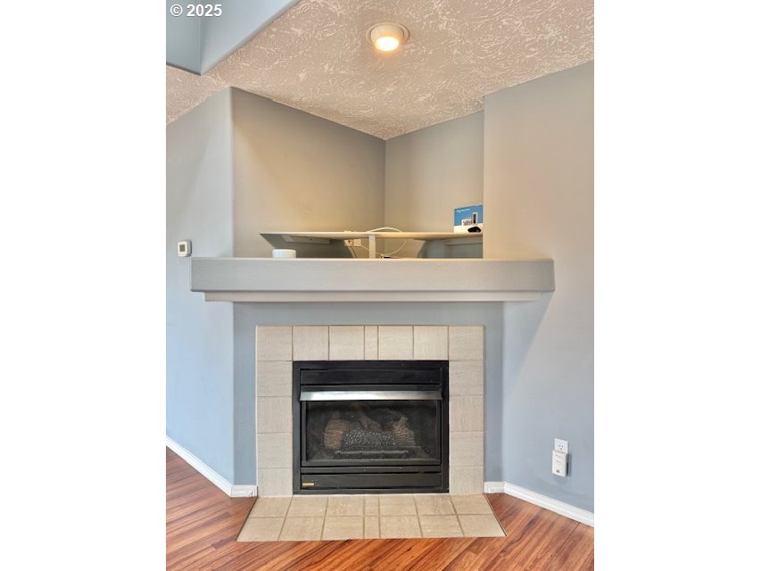 37355 Coralburst Street Sandy, OR 97055 - Photo 14 of 30 a living room with a fireplace and a rug