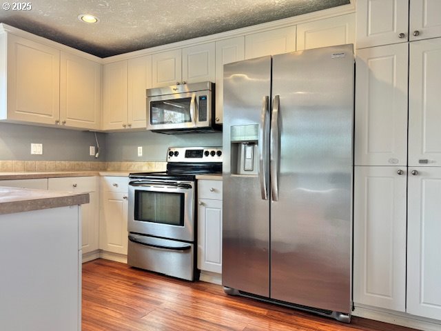 37355 Coralburst Street Sandy, OR 97055 - Photo 9 of 30 a kitchen with stainless steel appliances and a refrigerator