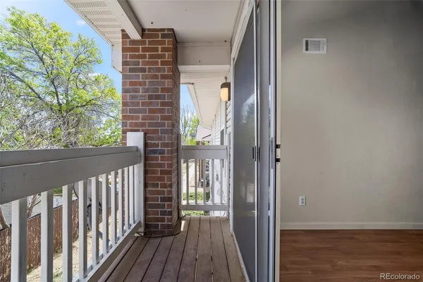 a view of balcony with wooden floor